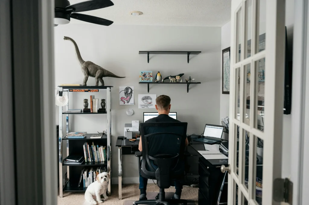 A man working on computer in a decorative room.